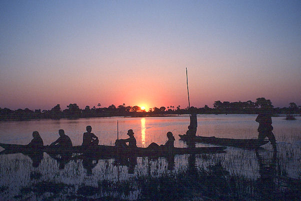 Us in a mokoro at sunset in the Okavango Delta